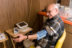 Ralph Terenzio a patient with the Center for Connected Health checks his blood pressure using remote monitoring equipment