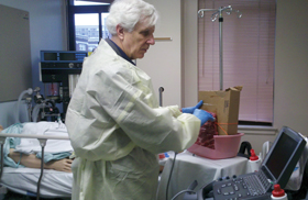 Michael Westley ACP Member of the Virginia Mason Medical Center in Seattle practices using ultrasound guidance to identify and tap fluid on a 5 slab of pork ribs before moving on to a 3000 pati