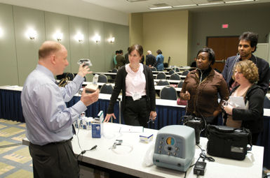 Paul A Selecky FACP left guides a hands-on course about properly using inhalers and oxygen delivery devices